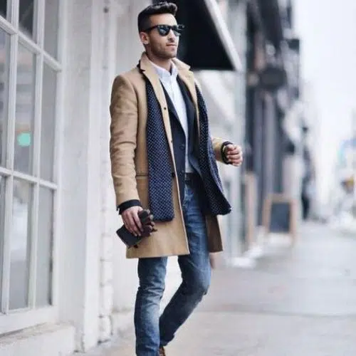 outfit elegante de invierno con abrigo camel y jeans para hombre