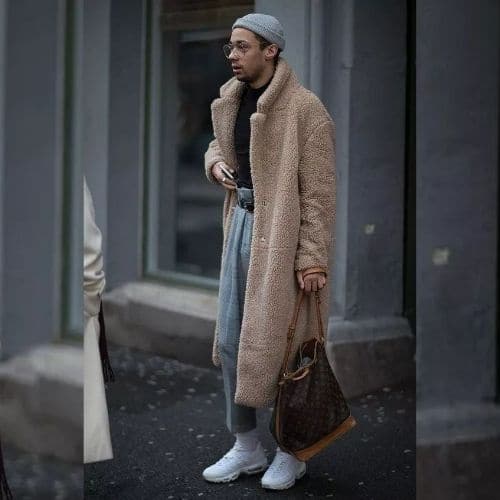Outfit para hombre con abrigo beige, jeans plisados y bolso tipo saco. 】